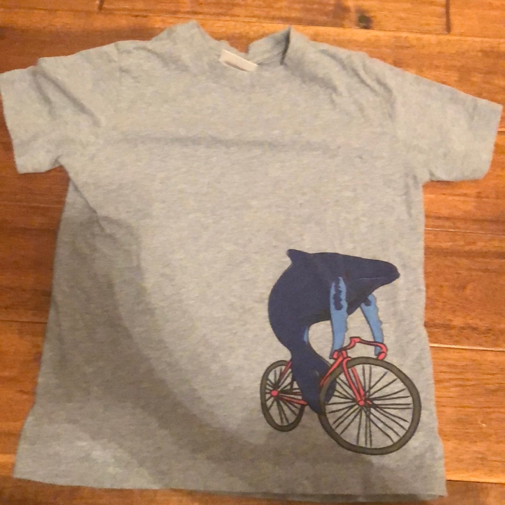 Blue heathered whale riding a bicycle